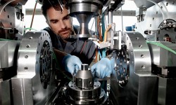 Engineer Nicolas Devaux makes adjustments to the Tribogyr test machine.