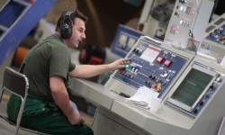 Operator controlling the corrugated board production process at Grigiškės paper mill.