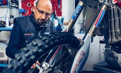 Paolo Drocco, co-owner of Innteck, mounting the front wheel on an off-road motorcycle.