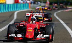 Sebastian Vettel celebrates as he approaches Parc Fermé after winning the Formula 1 Grand Prix of Hungary at Hungaro-ring on 26 July 2015 in Budapest, Hungary.